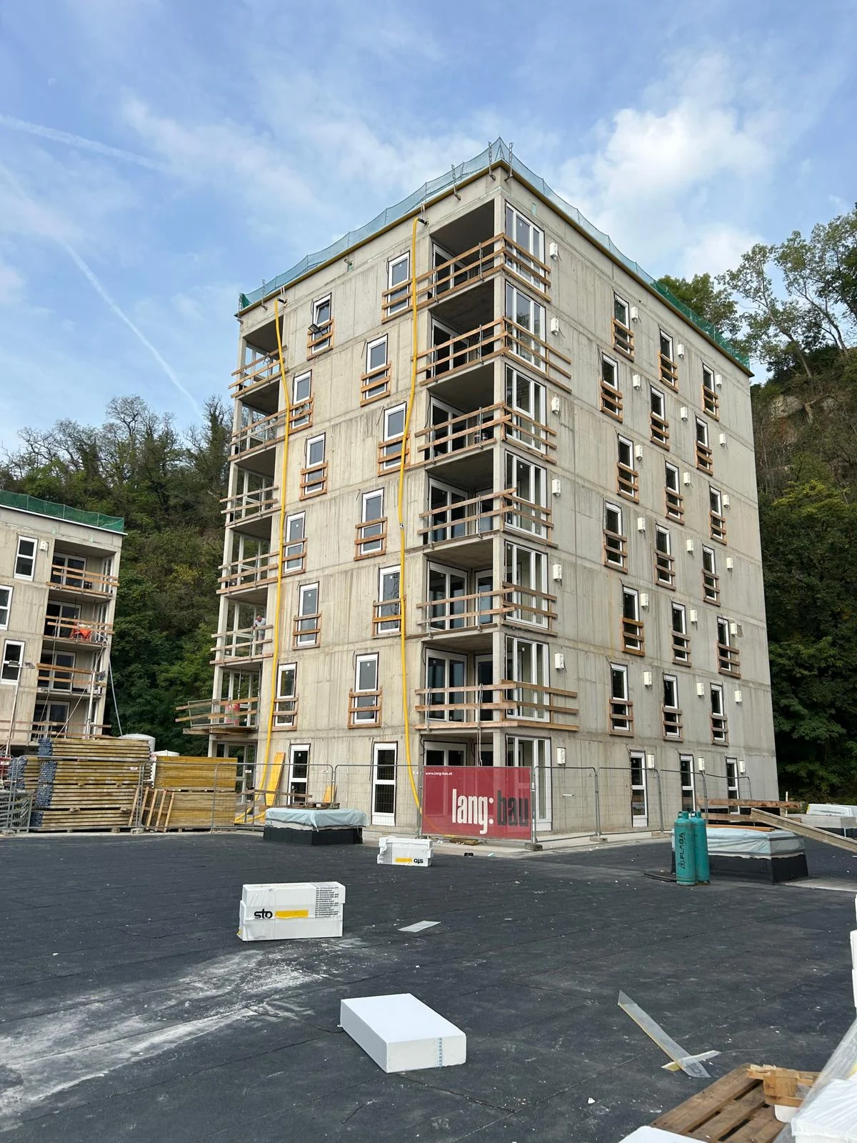 Mehrgeschossiger Neubau mit Fenstern und Balkonen